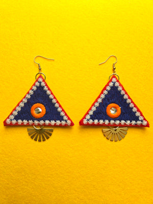 Embroidered Triangle Sunrays Earrings Blue embroidered fabric triangle shaped earrings with hints of orange, white, and red, as well as a small mirrored center. 18k gold plated stud backing. Length of earrings is 3.5 inches and width is 2.5 inches. Added brass charm that resembles sun rays.