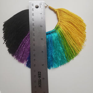 Fan shaped Multi-Colored Tassel Hoop earrings that are yellow, green, blue, purple, and black. Length measurement is 5 inches.